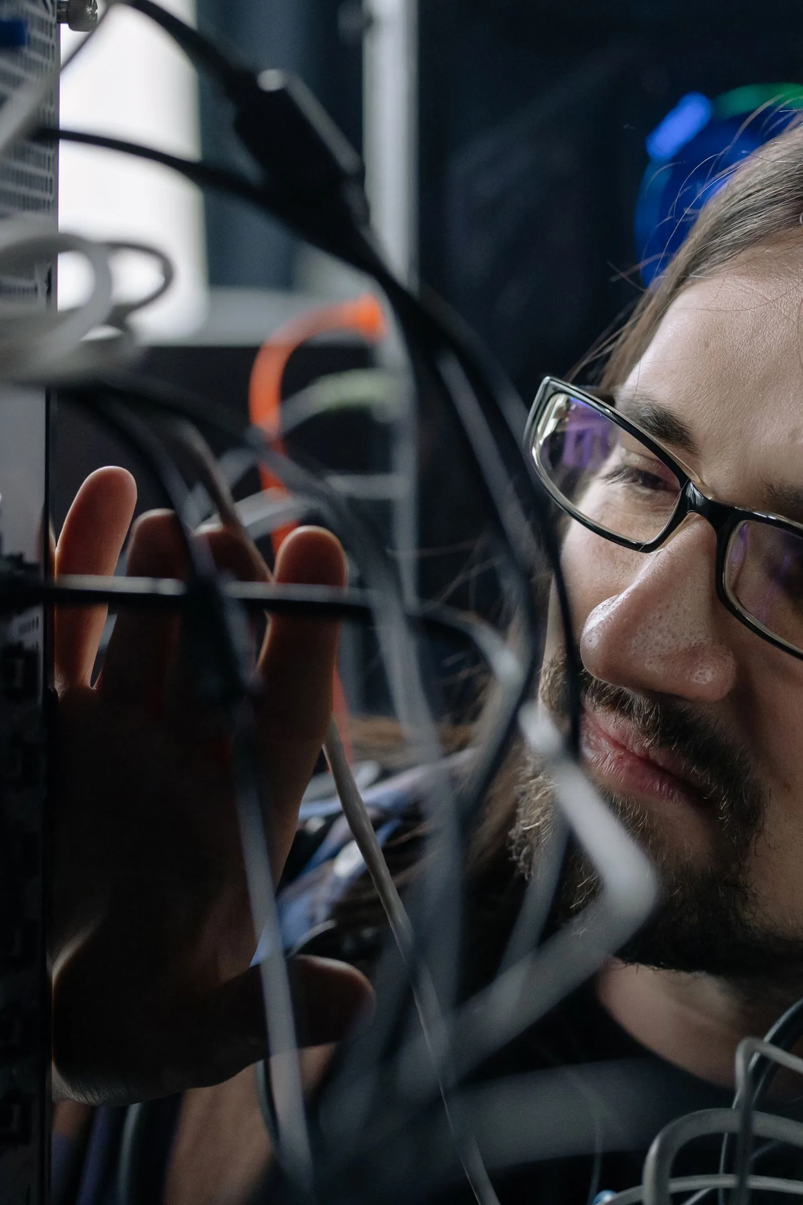 An IT professional checking server room cabling